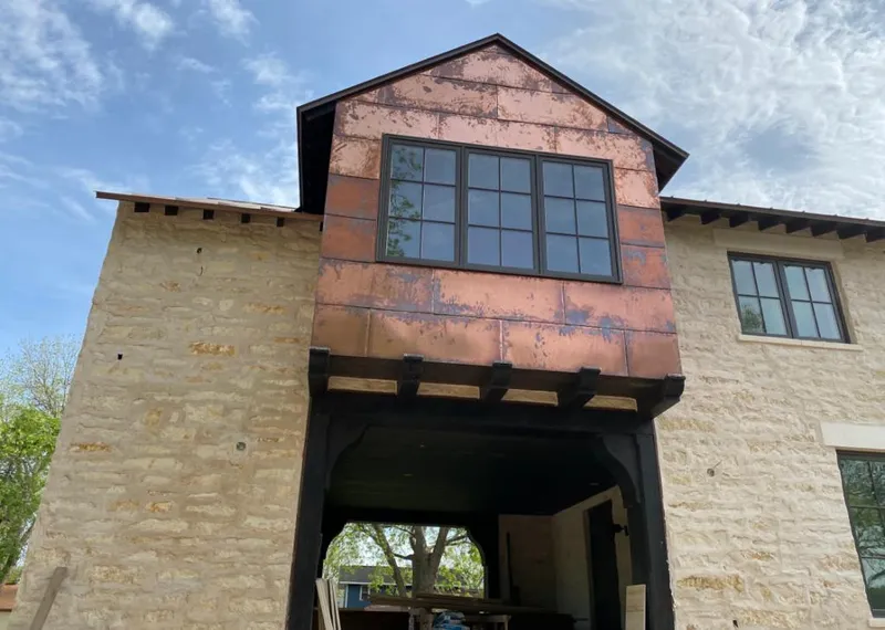 Copper metal panel facade on a stone building for Skylight Installation in Ocala