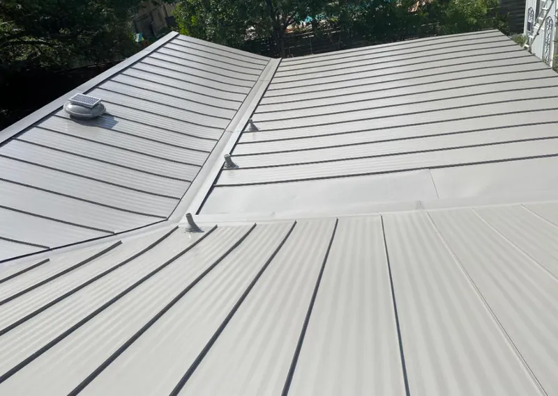 Solar attic fan installed on a metal roof for Roof Ventilation in Ocala
